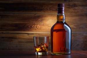 Bottle of whiskey on a wooden background